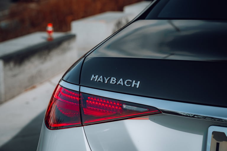 White luxury Maybach sedan rear angle